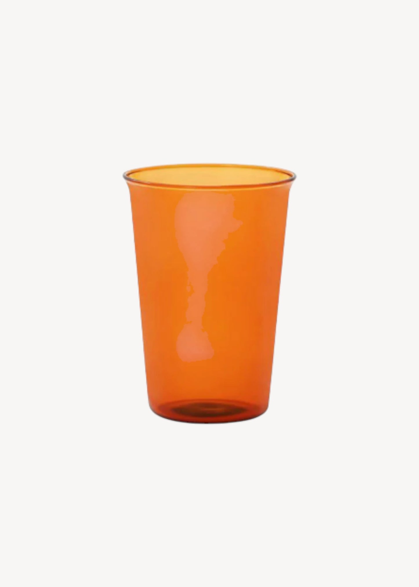Orange glass cup on a white background