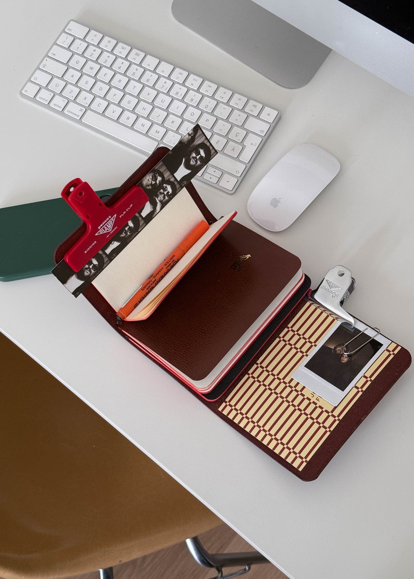 Open leather wallet with tools on a desk with keyboard and mouse