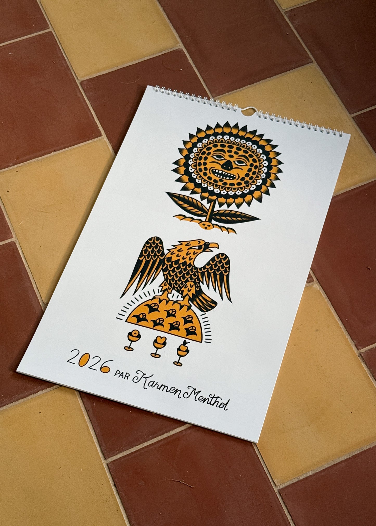 Calendar with artistic design on a tiled floor