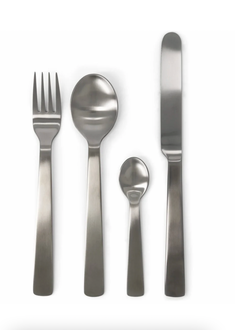 Set of silver cutlery including a fork, two spoons, and a knife on a white background