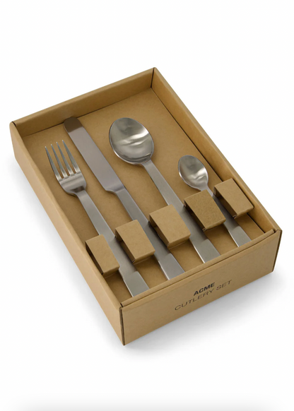 Set of silver cutlery in a cardboard box on a white background