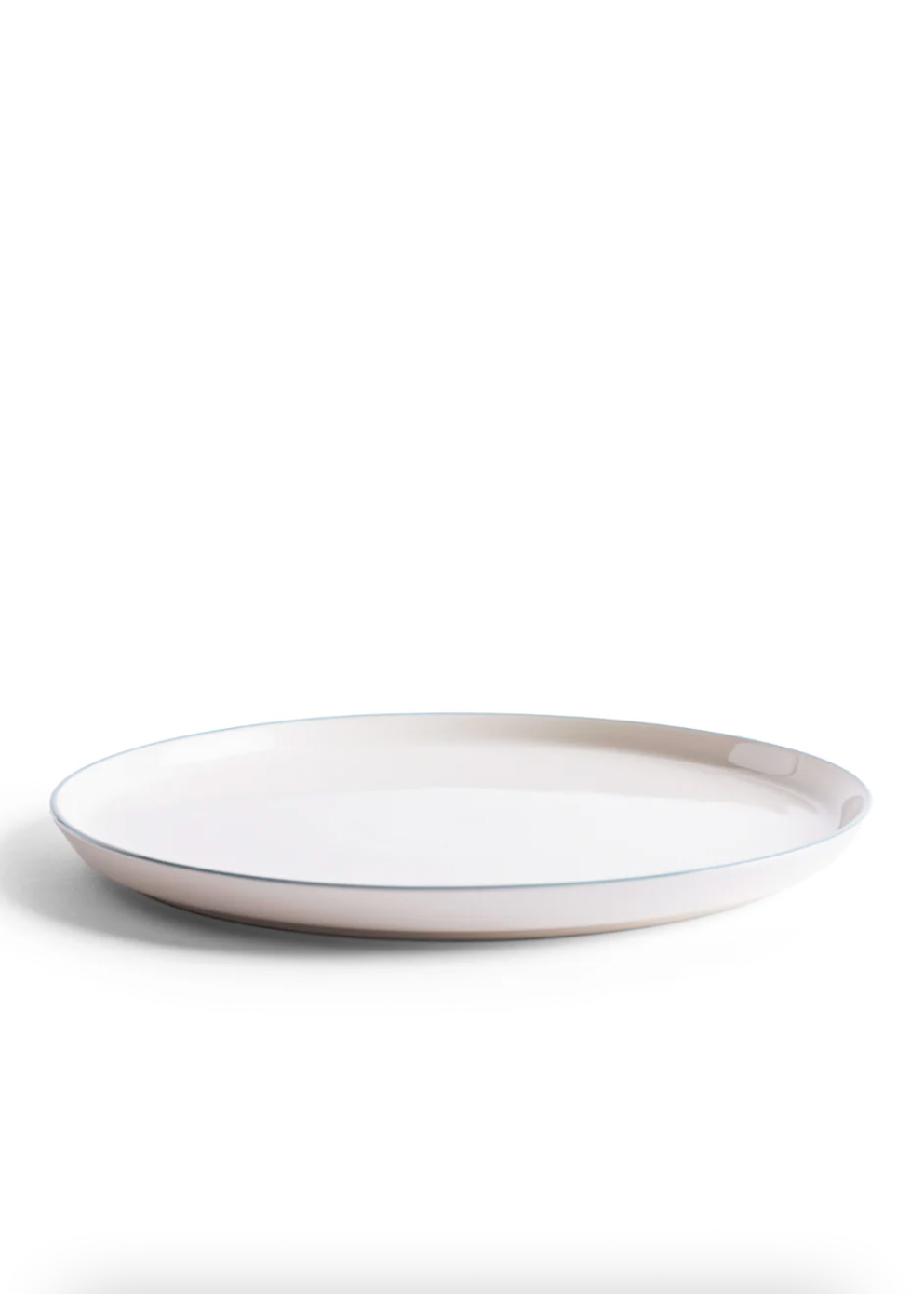 White ceramic plate with a thin rim on a white background
