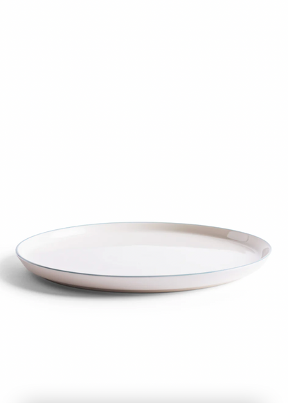 White ceramic plate with a thin rim on a white background
