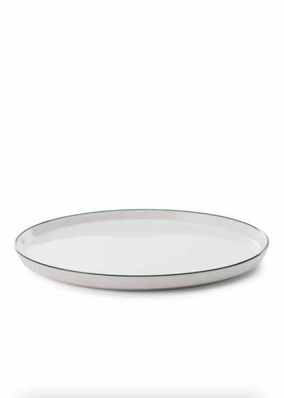 White ceramic plate with a thin black rim on a white background