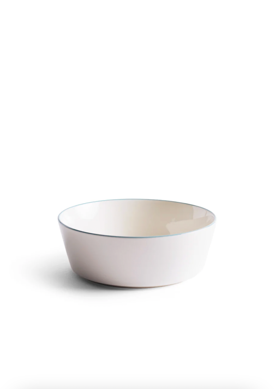 White ceramic bowl with a thin blue rim on a white background