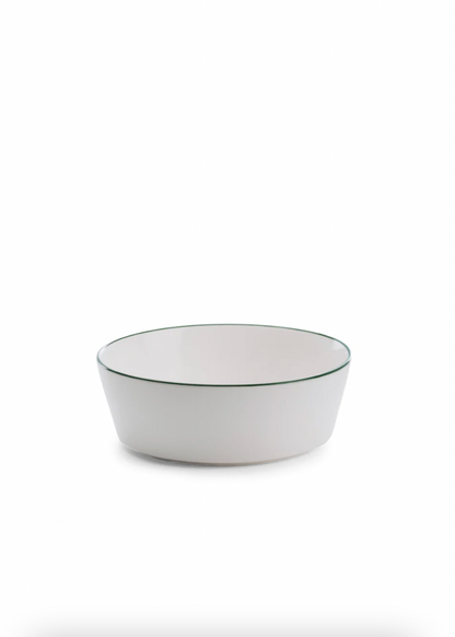 White bowl with a green rim on a white background