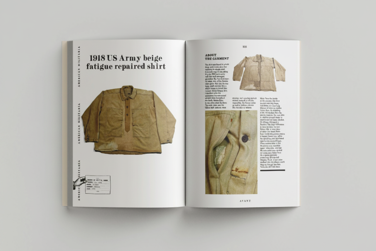 Open book showing a 1918 US Army beige fatigue repaired shirt with text on a gray background