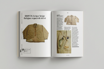 Open book showing a 1918 US Army beige fatigue repaired shirt with text on a gray background