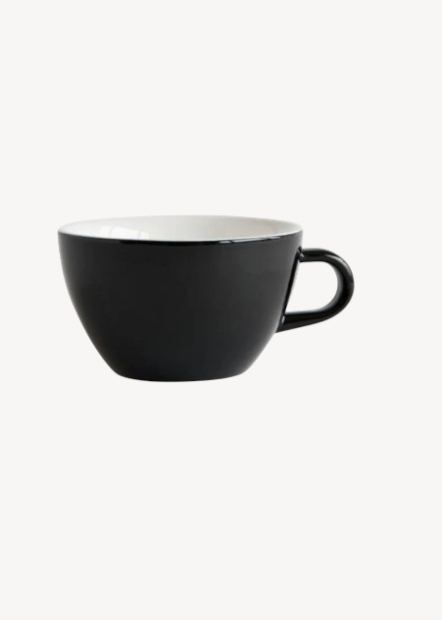 Black ceramic cup with a white interior on a white background