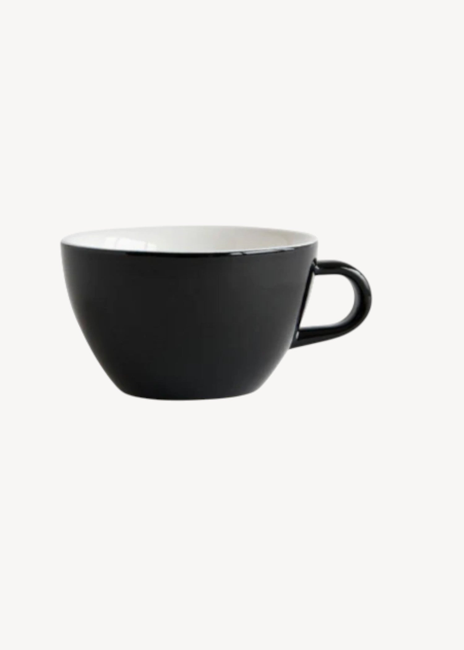 Black ceramic cup with a white interior on a white background