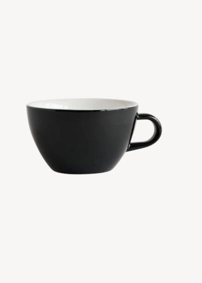 Black ceramic cup with a white interior on a white background