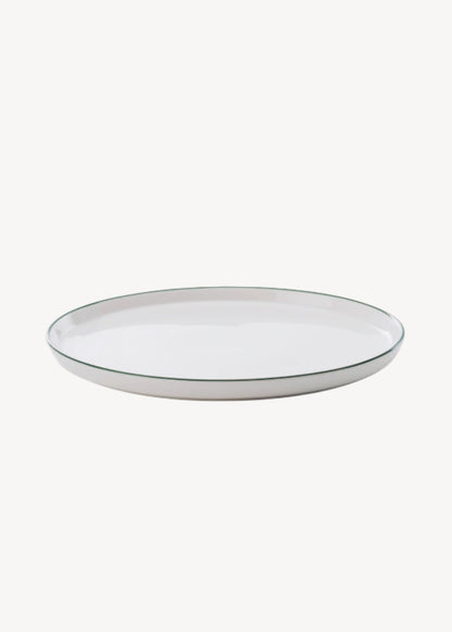 White plate with a thin black rim on a white background
