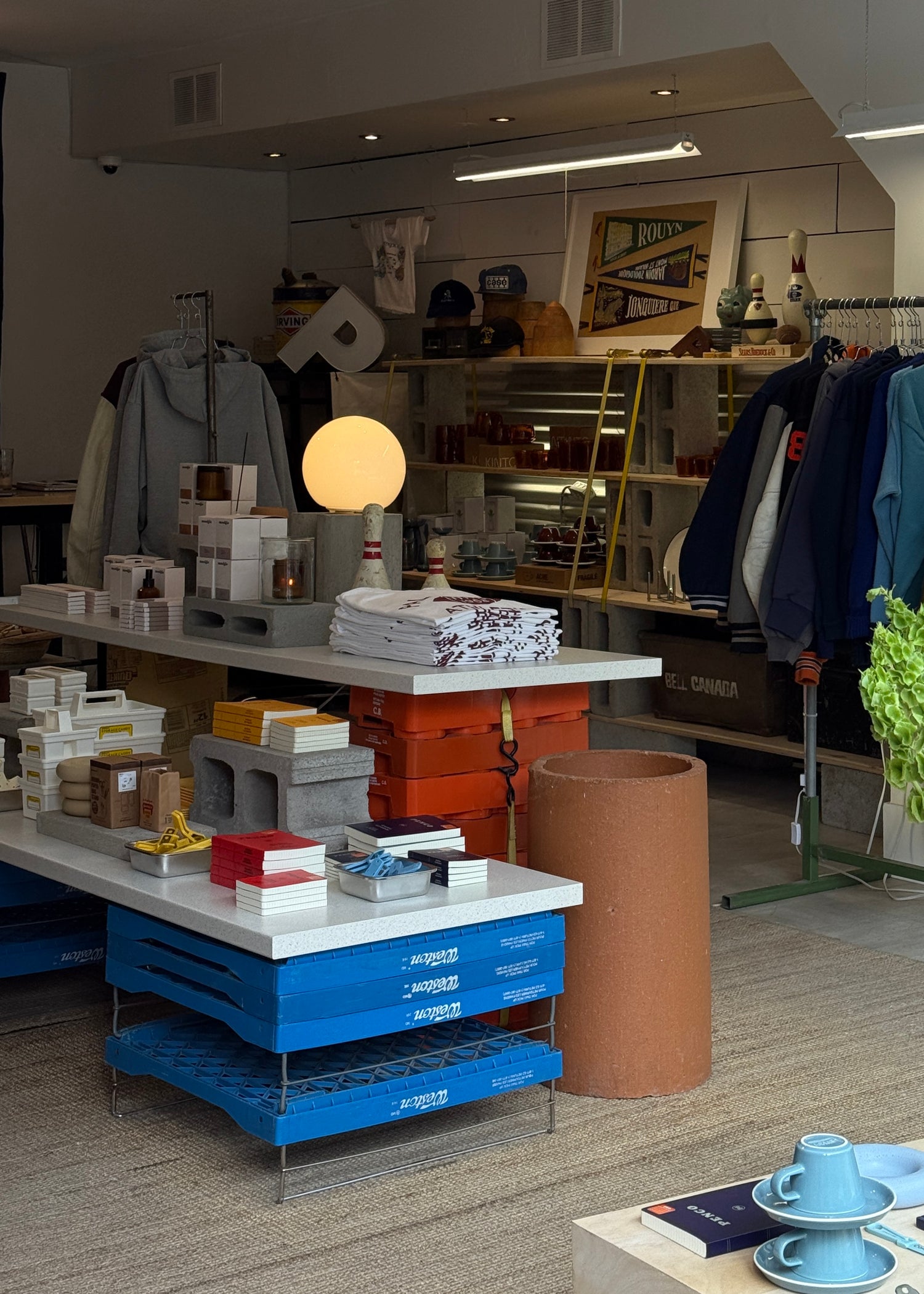 Interior of a store with shelves, tables, and various items on display.