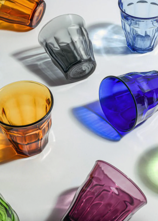 Colorful glass tumblers on a white surface