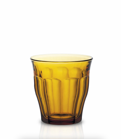 Yellow glass tumbler on a white background