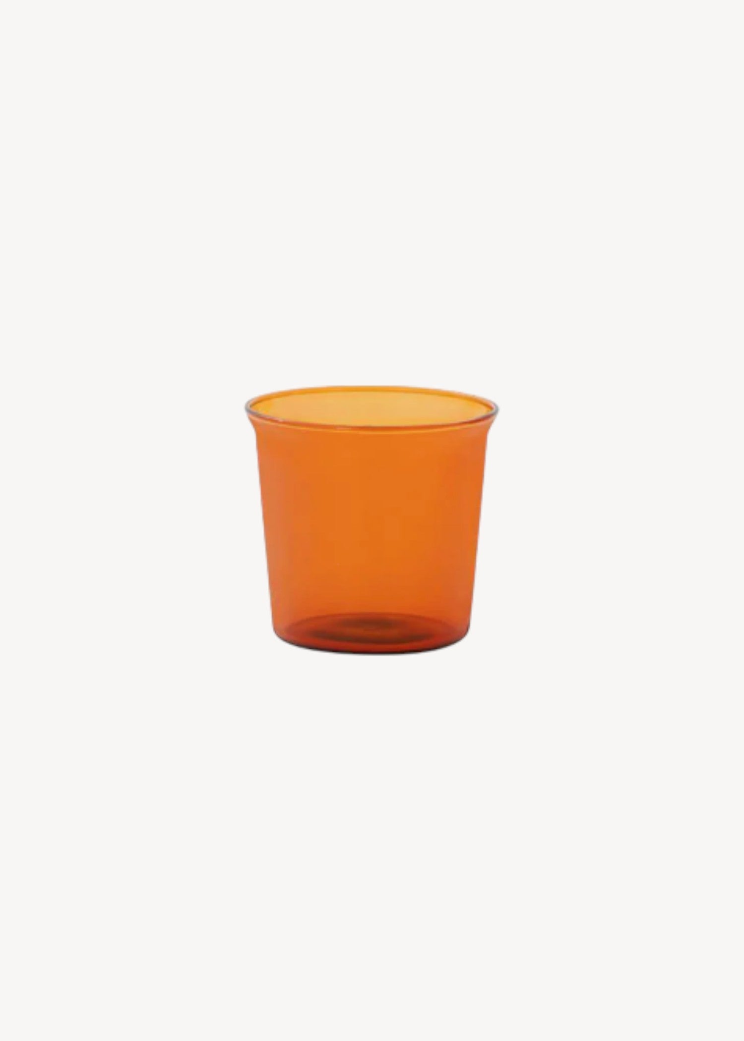 Orange glass cup on a white background