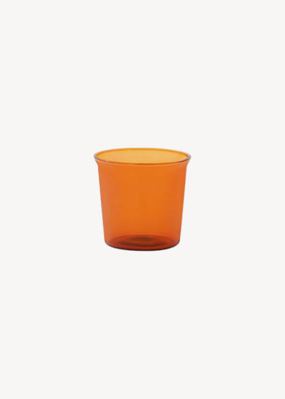Orange glass cup on a white background