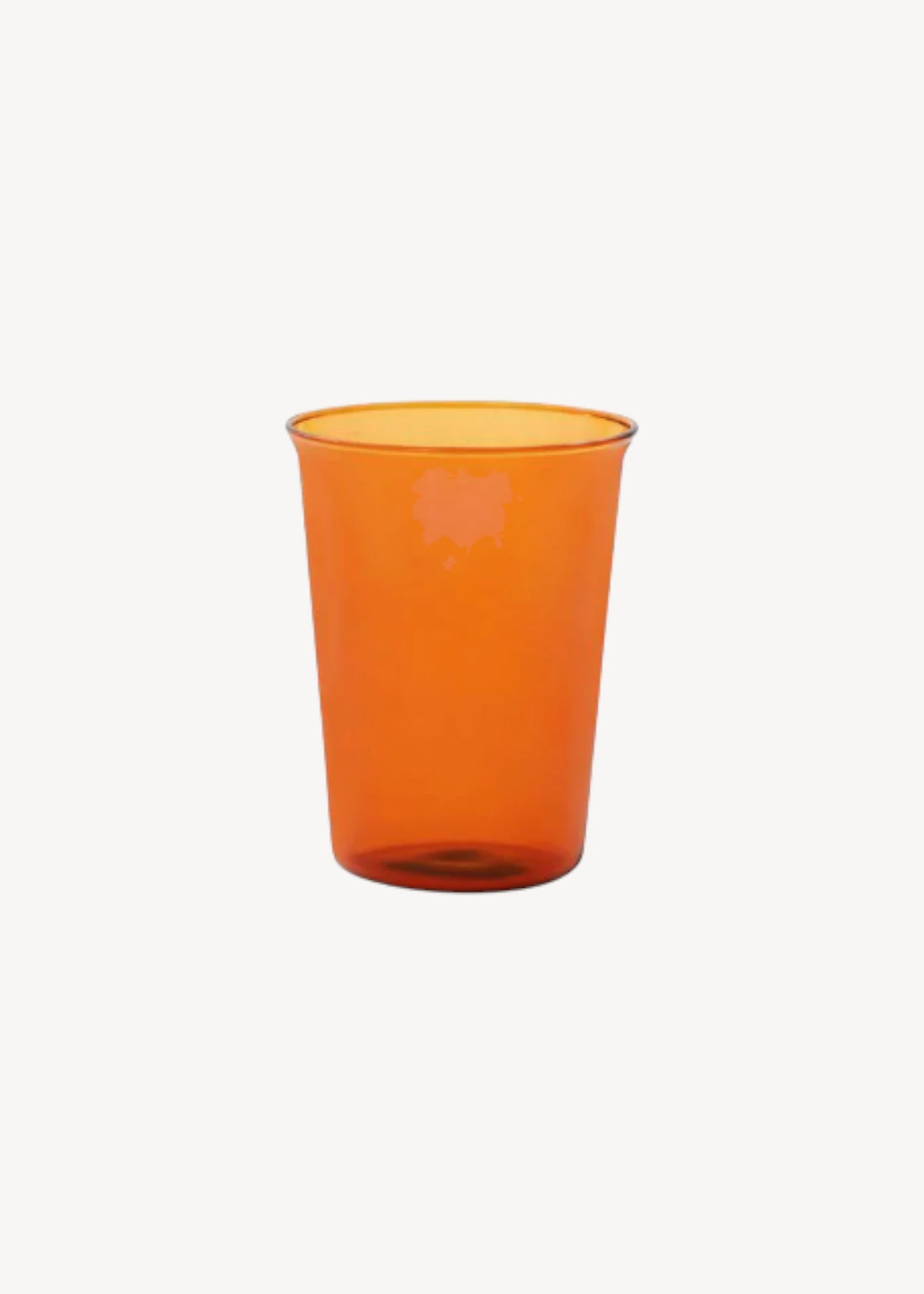 Orange glass cup on a white background