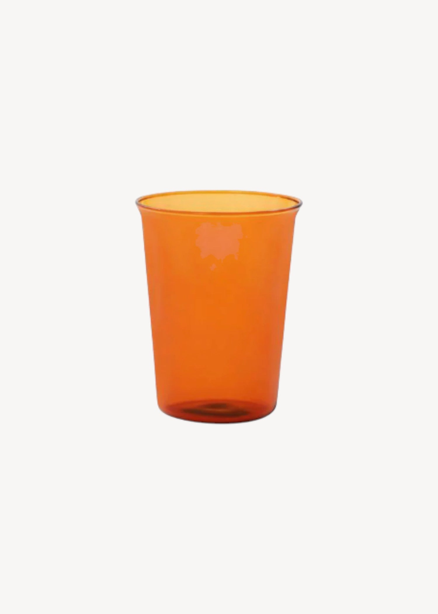 Orange glass cup on a white background