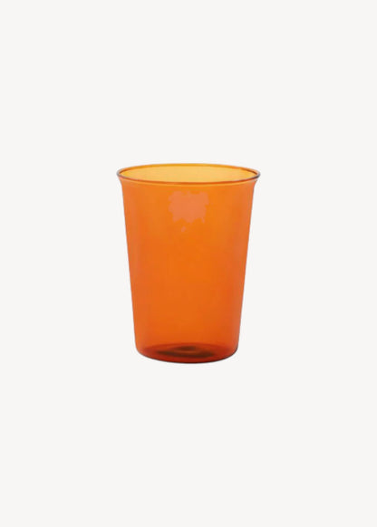 Orange glass cup on a white background