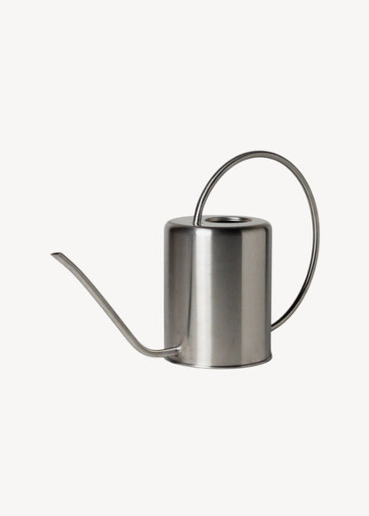 Stainless steel watering can on a white background
