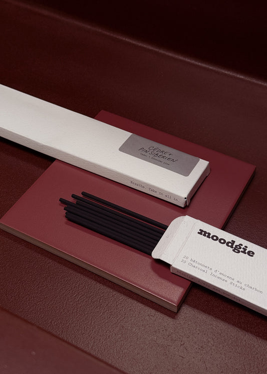 Moodgie incense sticks with packaging on a maroon surface