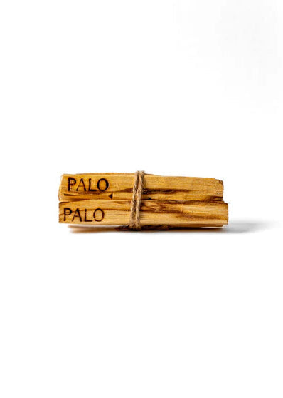 Four wooden palo santo sticks tied together with 'Palo' branding on a white background