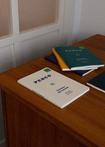 Penco A5 notebooks on a wooden surface with a neutral background