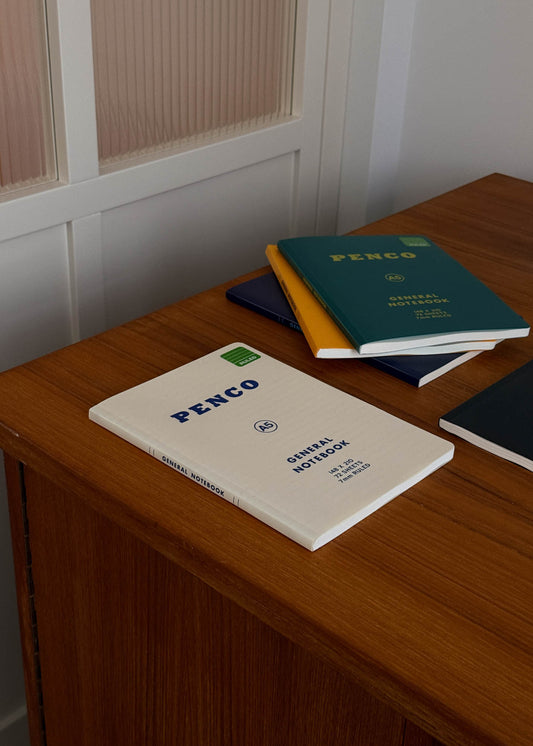 Penco A5 notebooks on a wooden surface with a neutral background