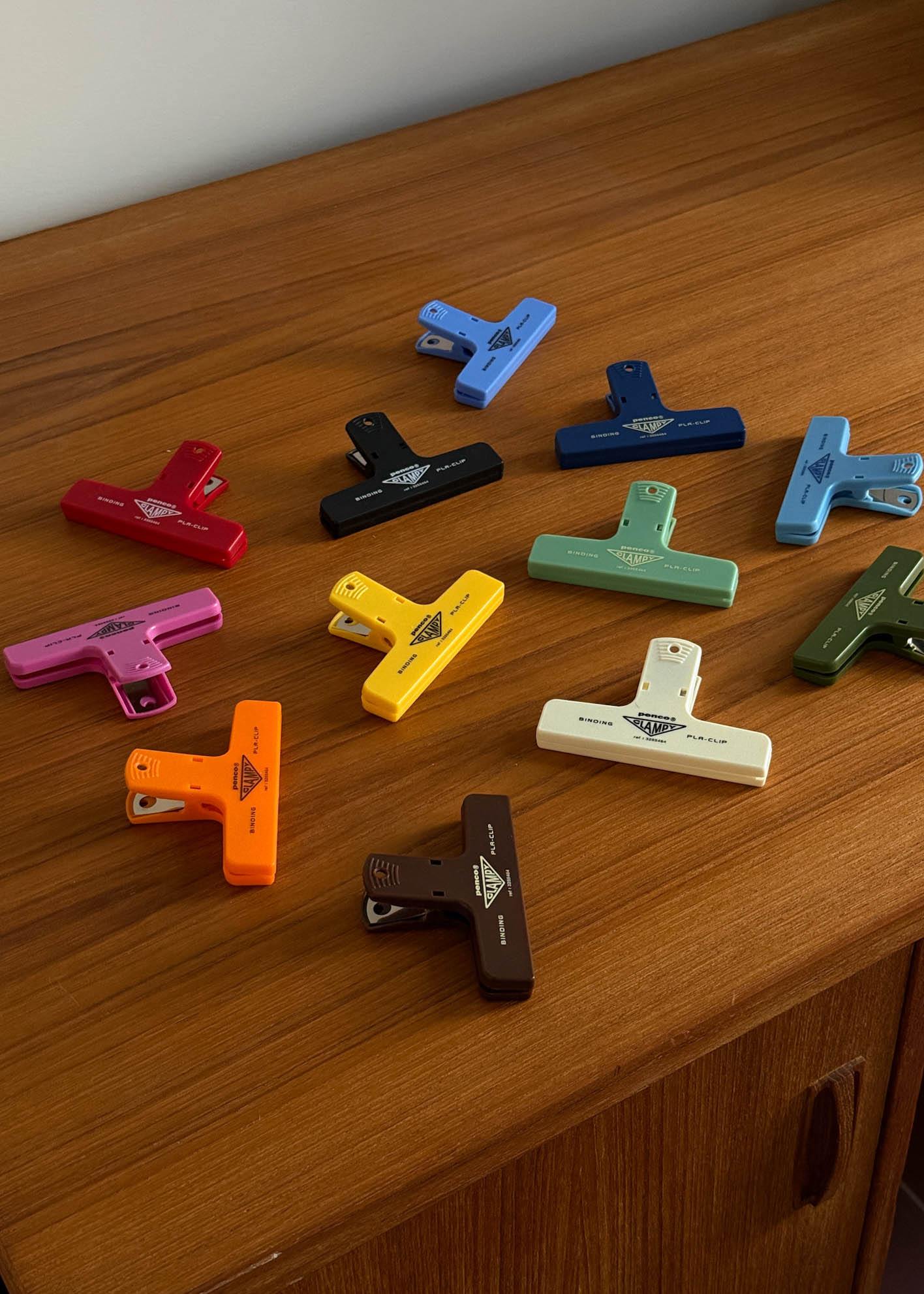 Colorful plastic clips arranged on a wooden surface
