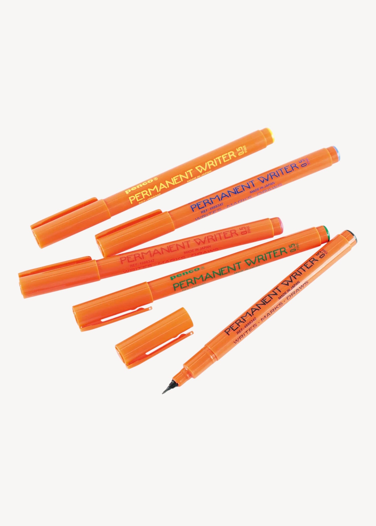 Set of orange permanent markers on a white background