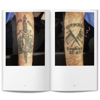 Open book showing two aged tattoos on peoples arms