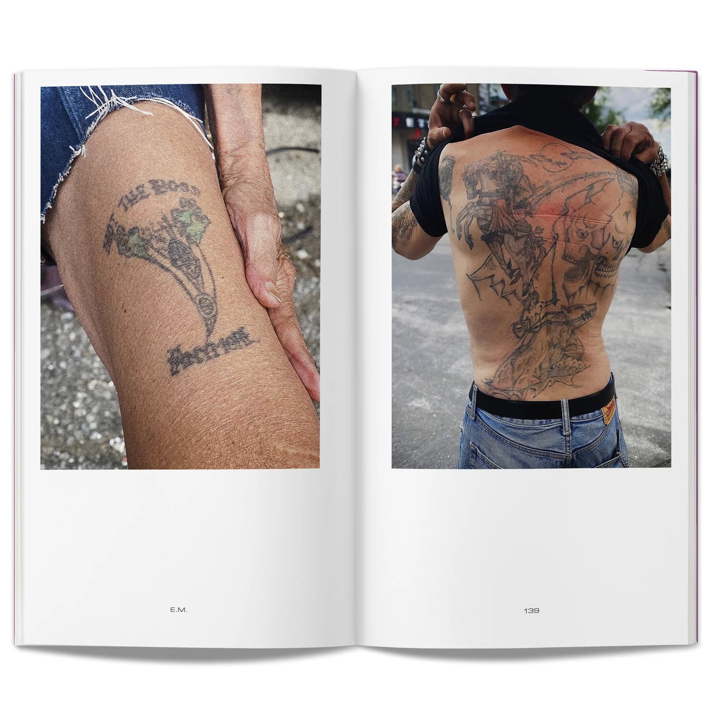 Open book showing photographs of aged tattoos on a person's arm and back.
