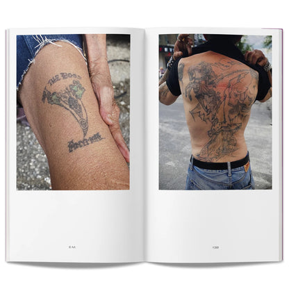 Open book showing photographs of aged tattoos on a person's arm and back.