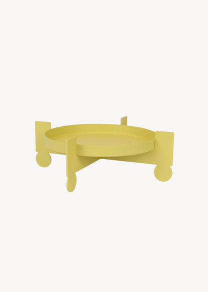 Yellow decorative item with a curved design on a white background