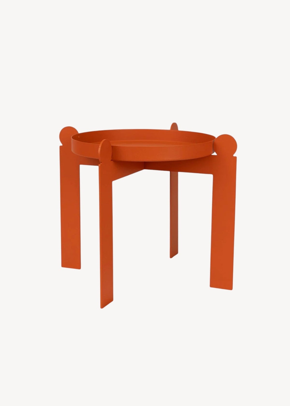 Orange geometric metal plant stand on a solid cream background